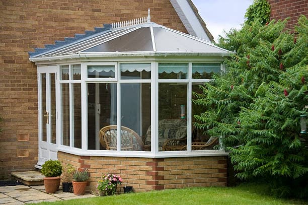 Glass conservatory attached to a home